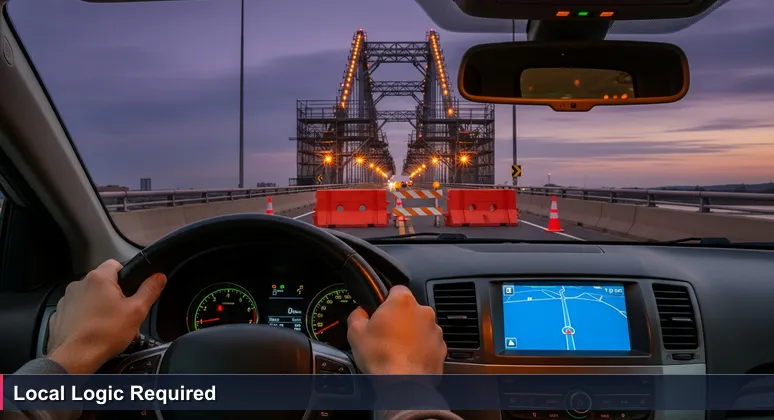 Driver's hands on a steering wheel at dusk, GPS screen showing a blue route, road blocked by a 'BRIDGE OUT' sign with a bridge under construction ahead.