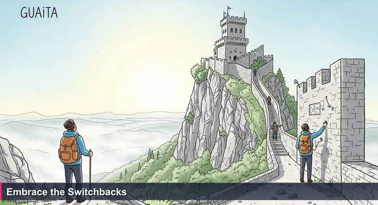 A lone hiker stands at the base of the Guaita tower in San Marino, looking up at the first fortress. A steep, winding stone path zigzags up the cliffside, disappearing behind rocks and reappearing higher. Morning mist in the valley below.